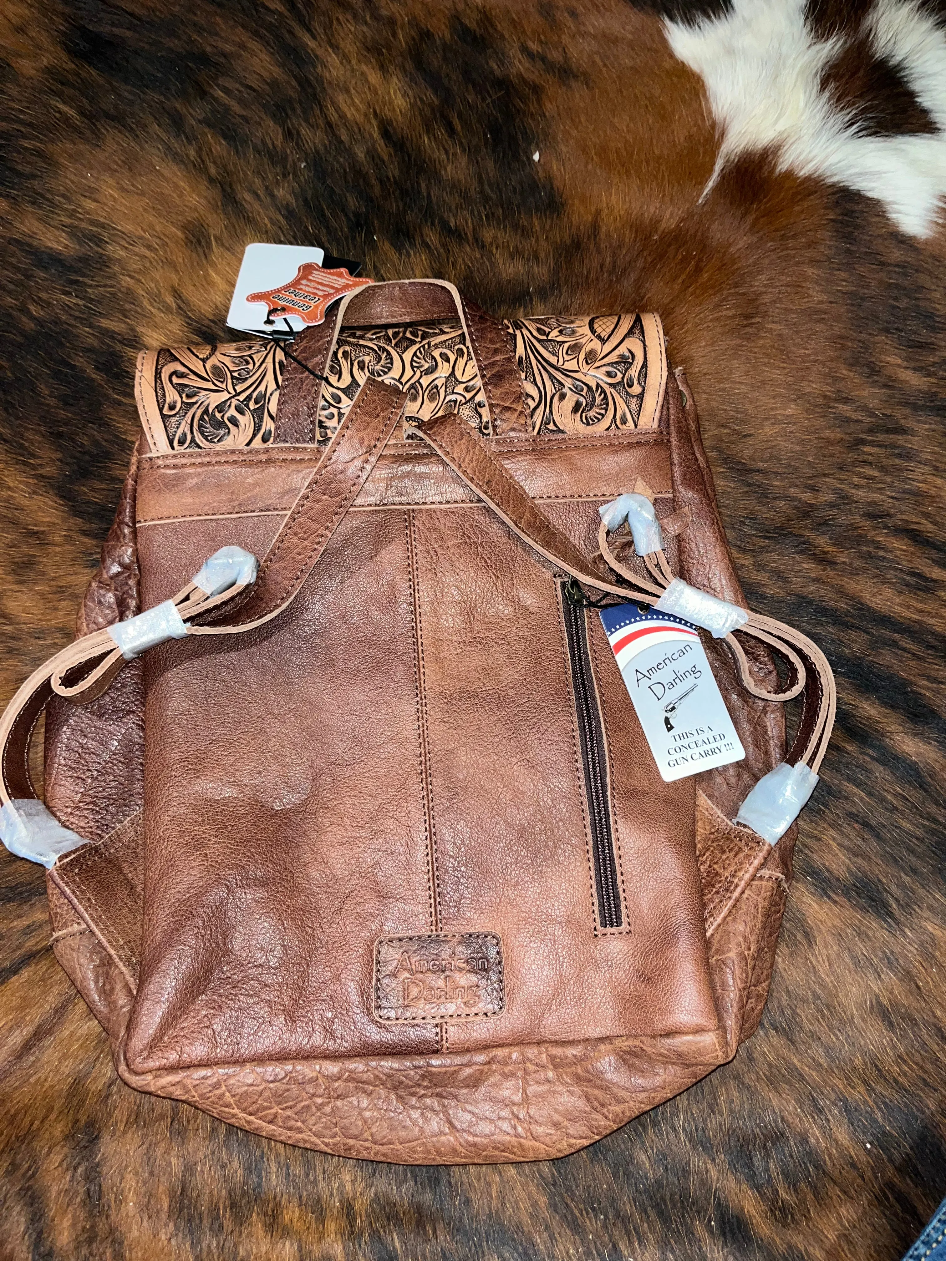 Cowhide and tooled leather concealed carry backpack purse